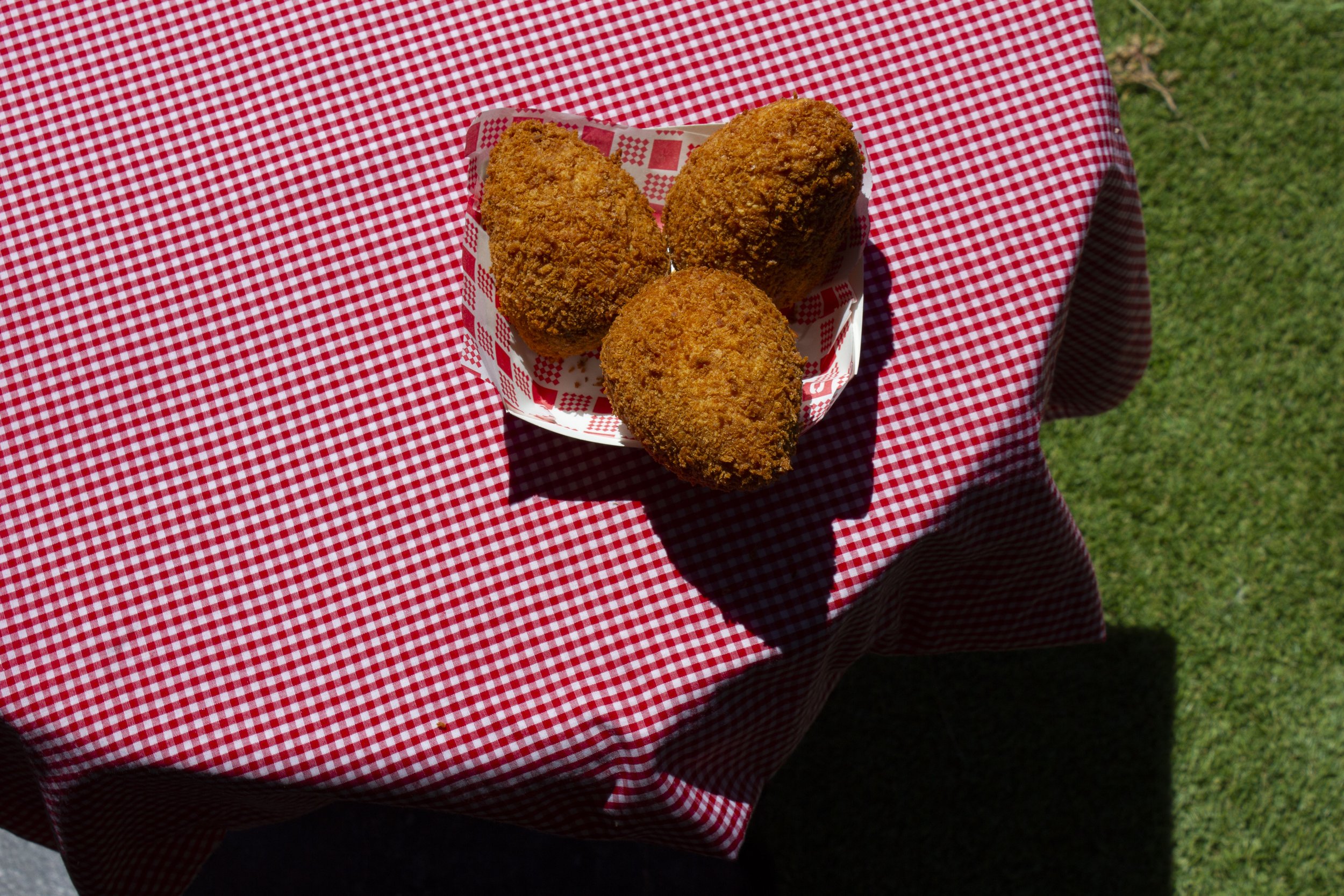 A tray of freshly fried arancini ready to serve